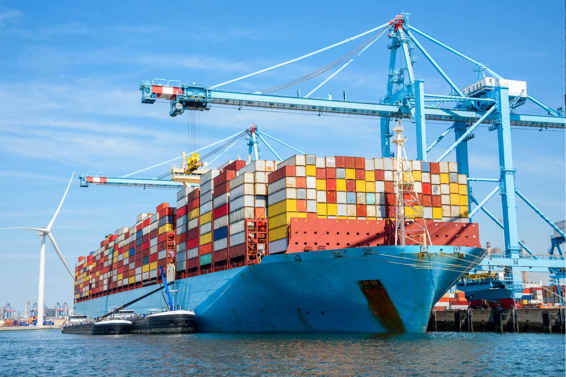 Image of a port with a large boat carrying containers