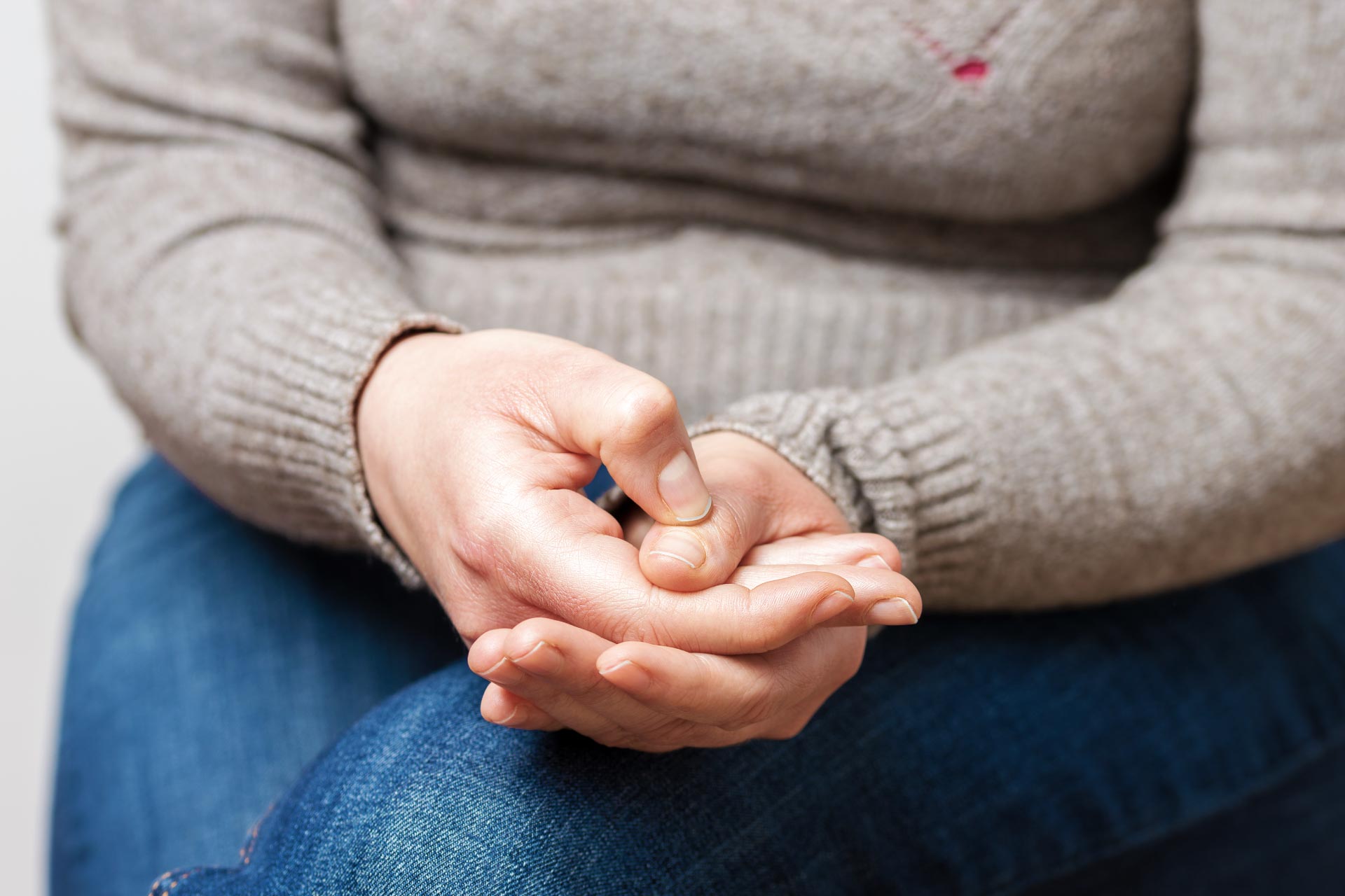 Image of woman stressed holding her hands together