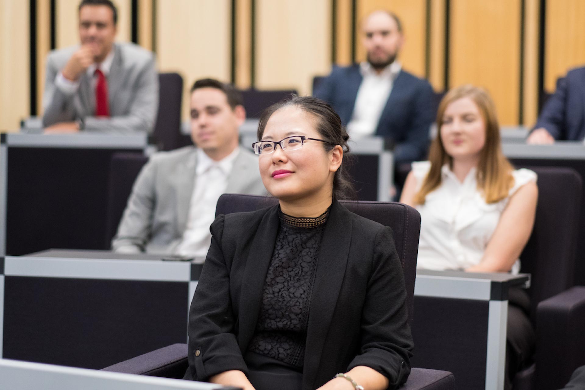 Female mature business executive student attending a class.