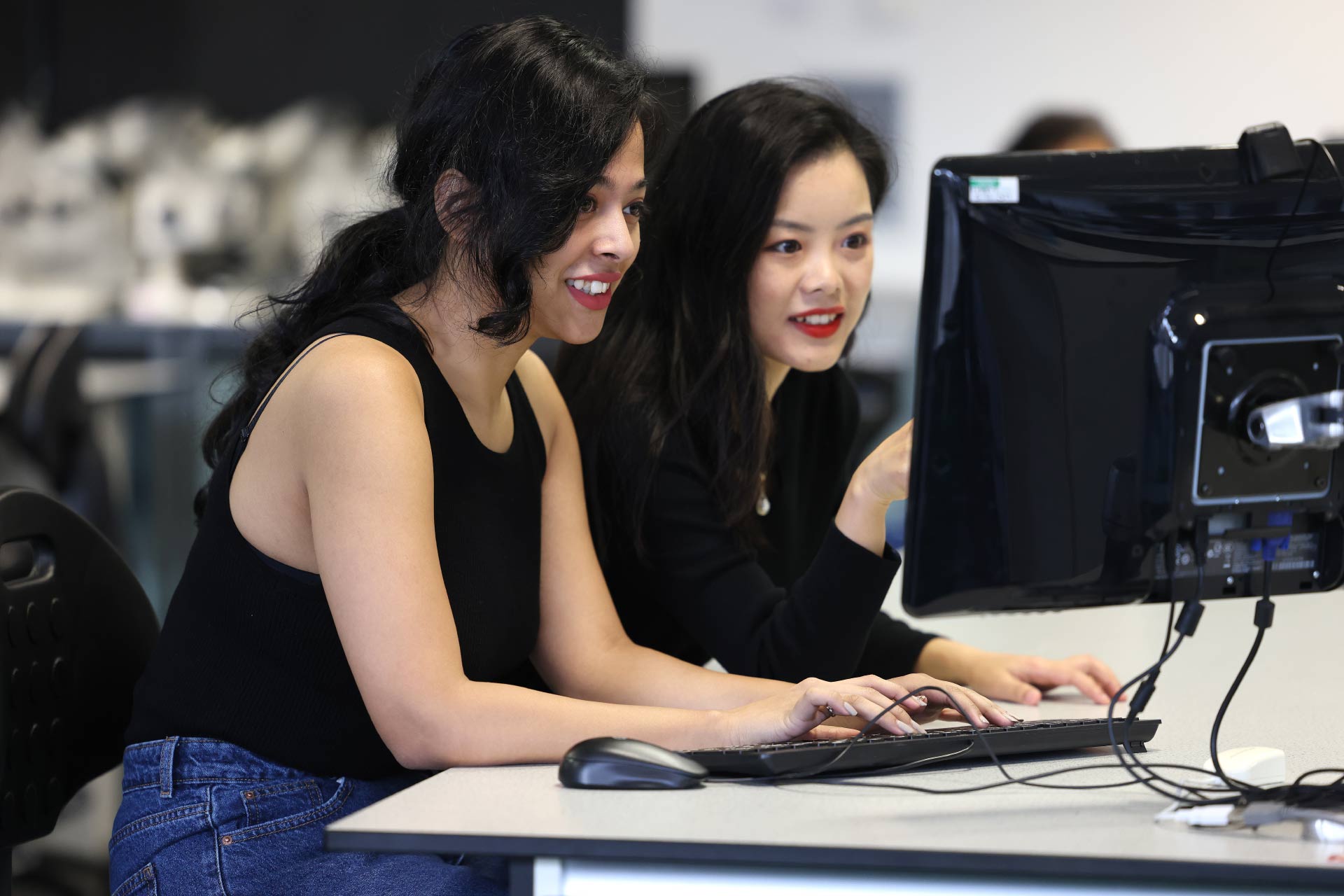 Two female students working on a computer