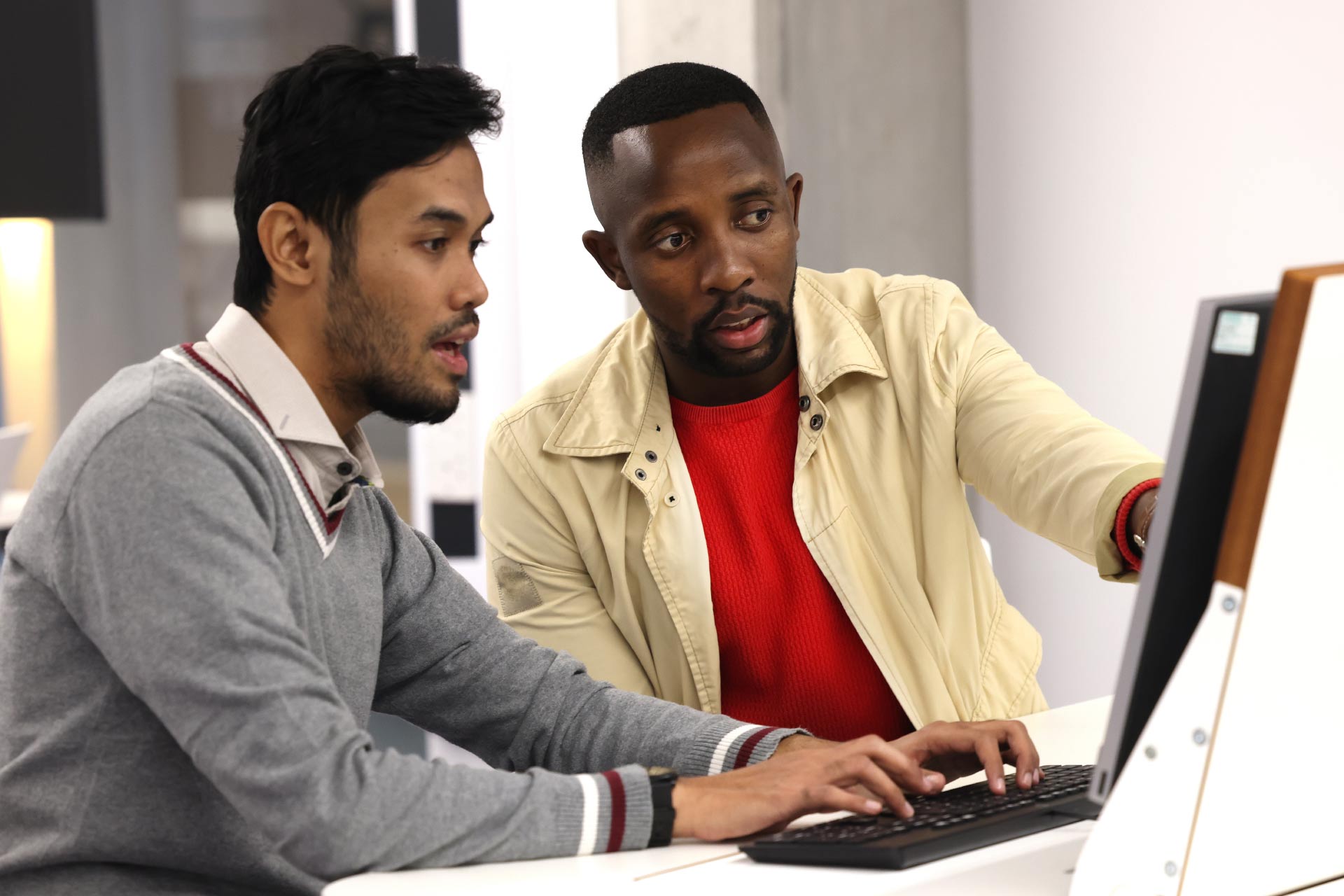 Two male students working on a computer