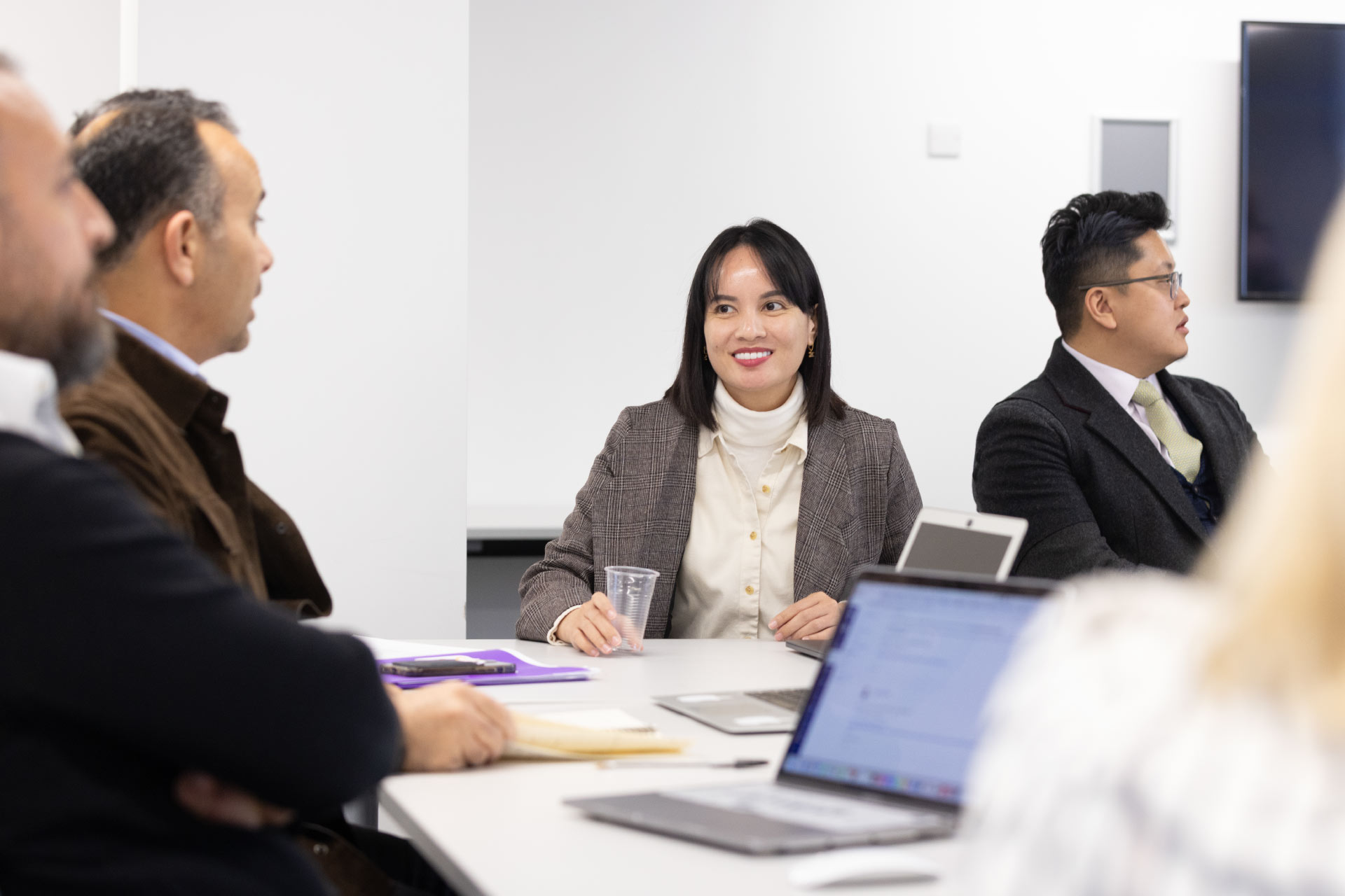 Male and female mature executive students talking during class