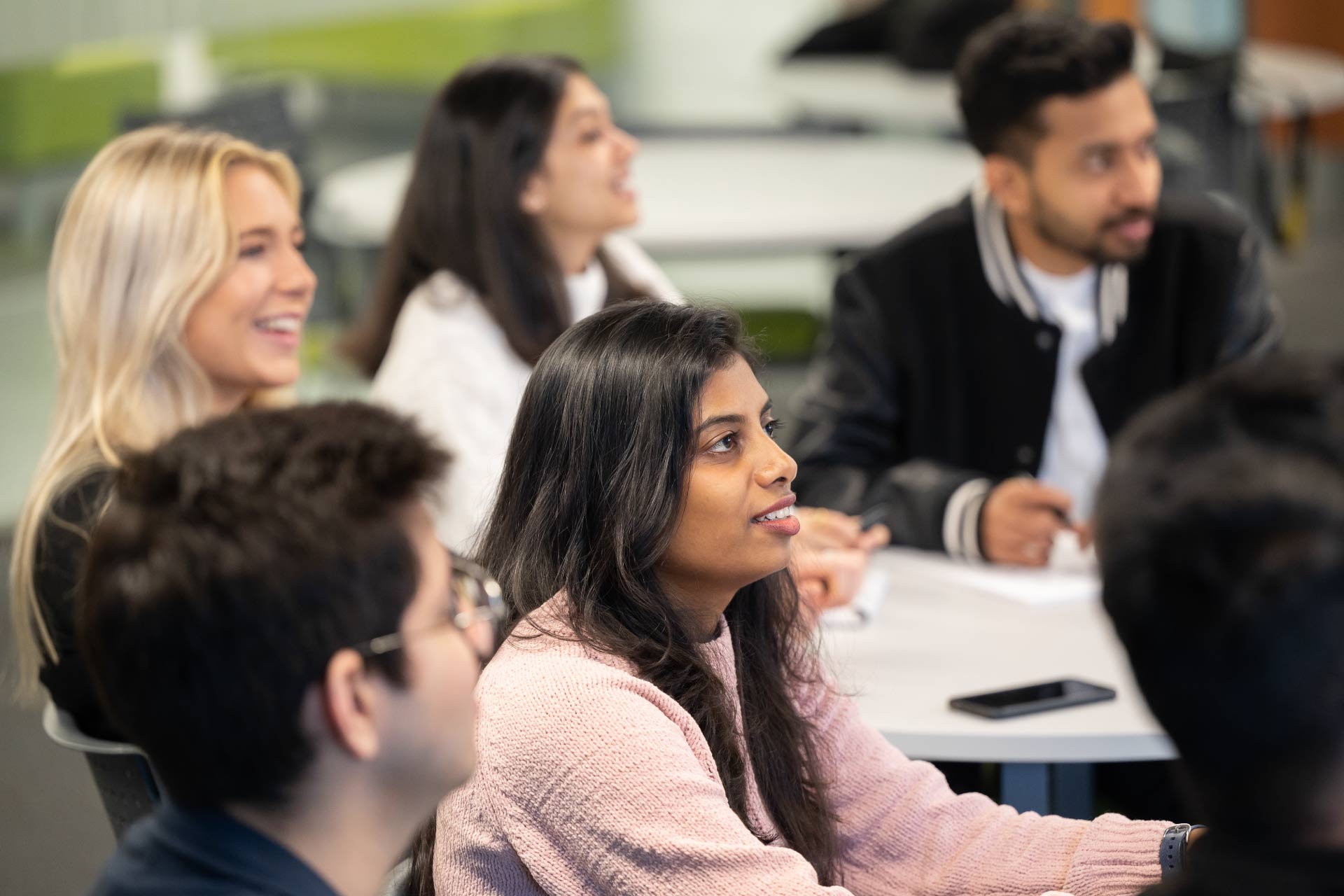 Group of young students attending a lecture