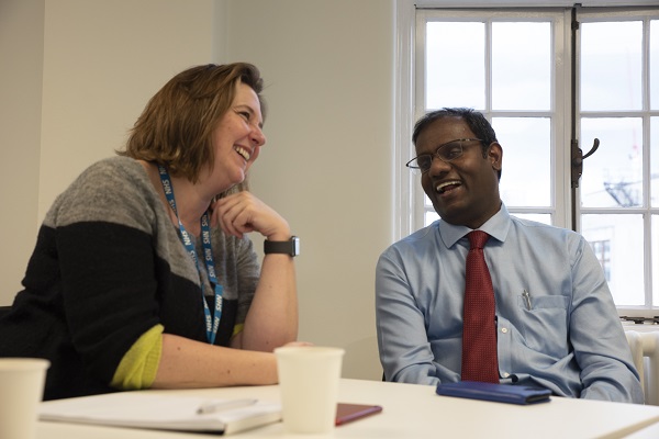 Two people laughing during a workshop