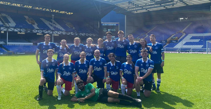 LMS men and women\'s teams pose on the pitch at Everton stadium