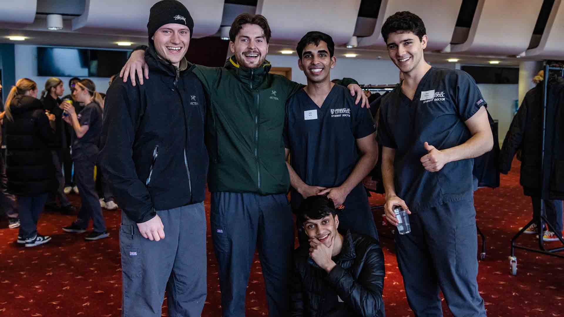 student doctors in medical scrubs as they wait to take a clinical assessment at Aintree racecourse