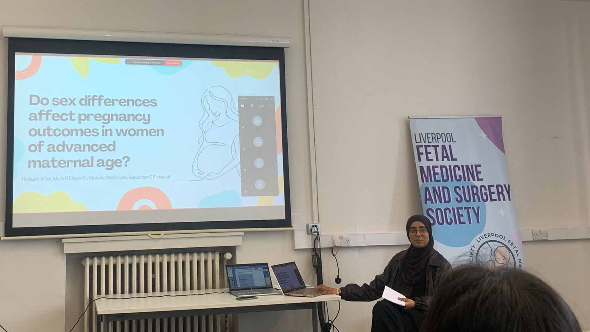 Presenter with slide that reads Do sex differences affect pregnancy outcomes in women of advanced maternal age?