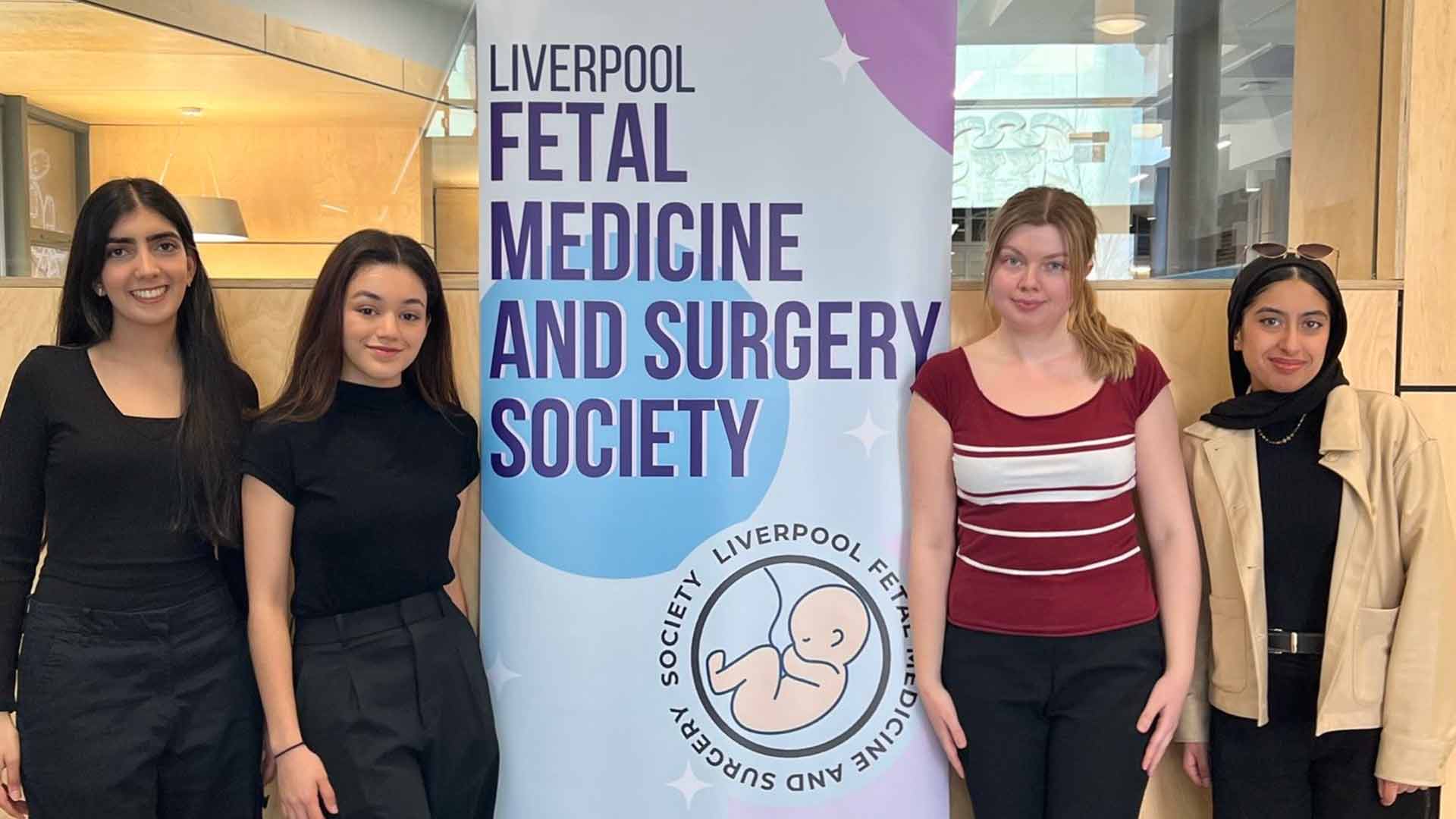 group of students standing with a banner that reads Liverpool Fetal Medicine & Surgery Society