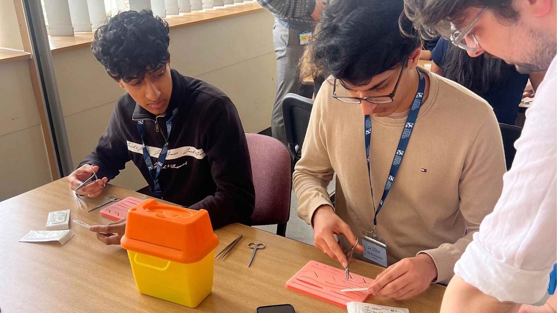 Two aspiring surgeons developing surgical skills at the Liverpool Future Surgeons Conference