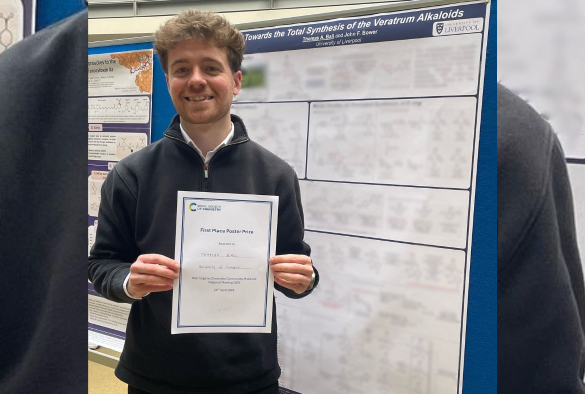 tom ball standing infront of his award winning poster