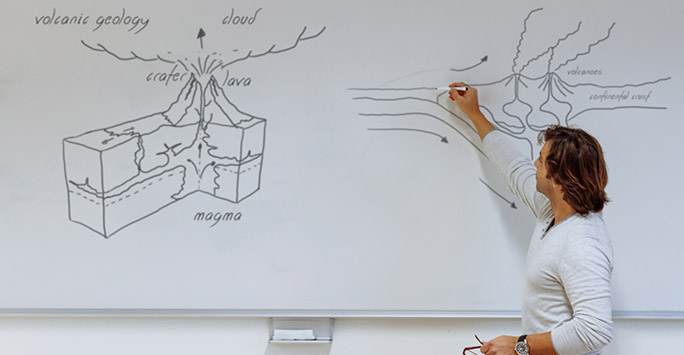 Geology teacher at whiteboard Geology teacher at whiteboard