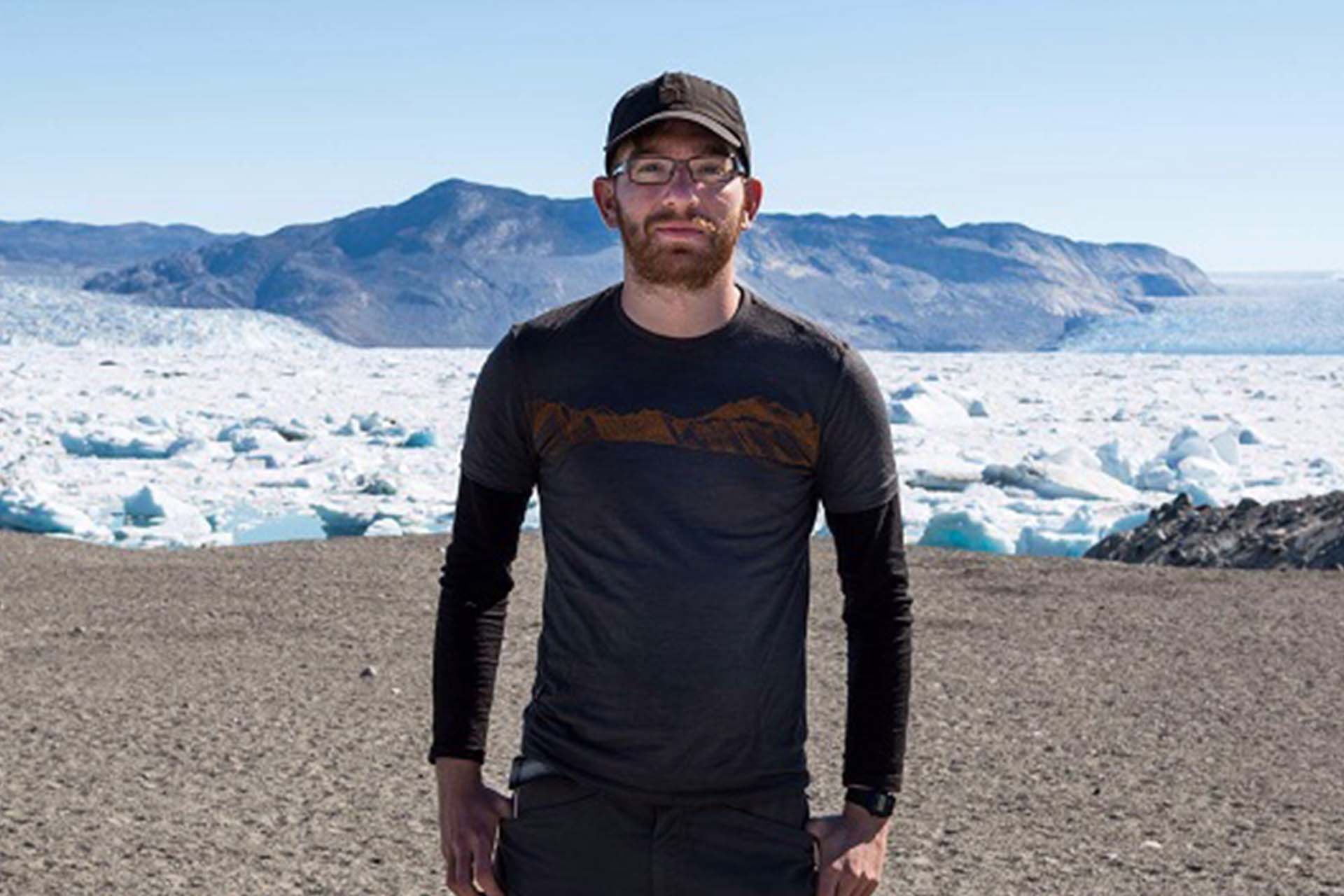 Dr James Lea standing on a beach