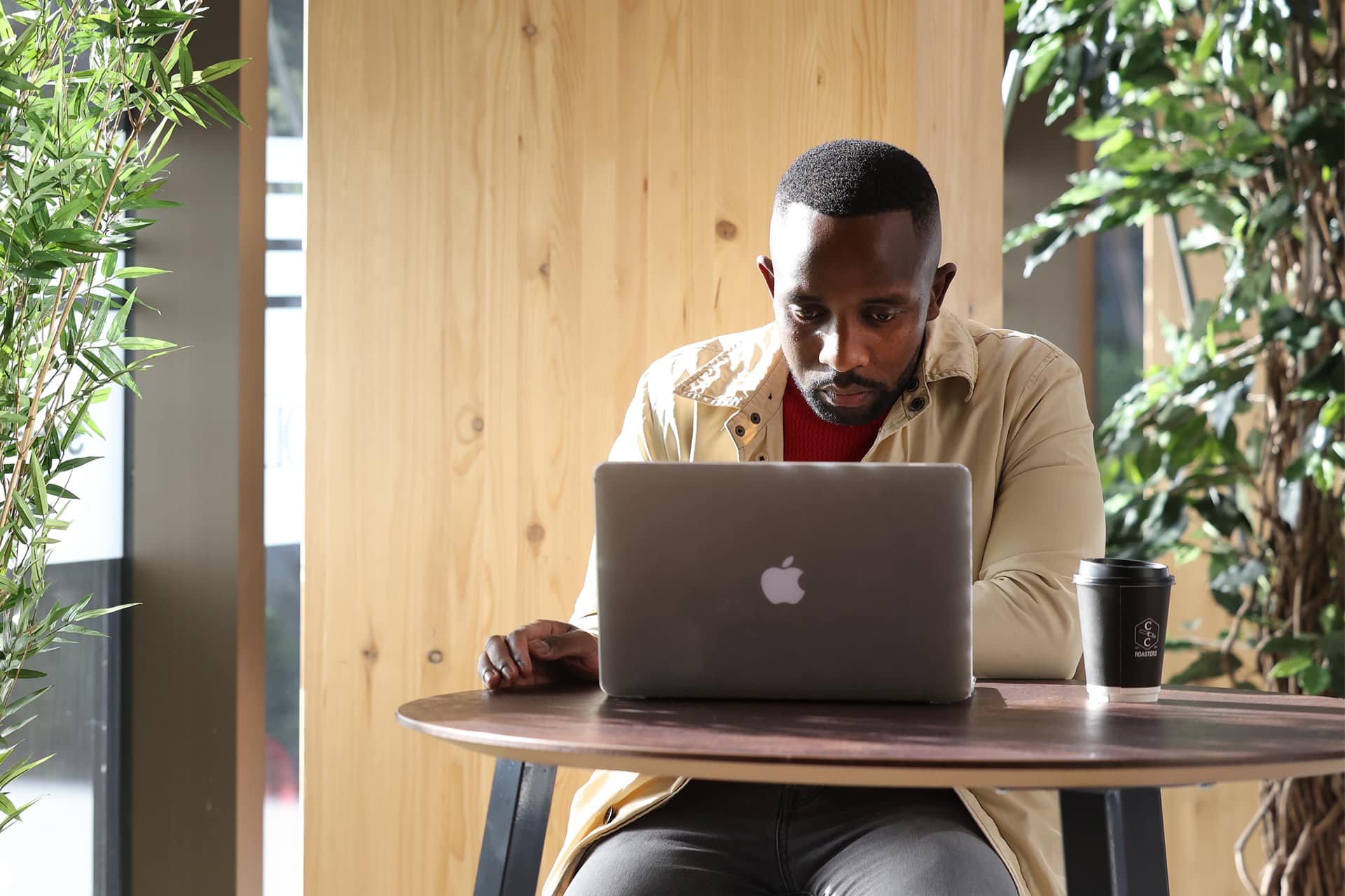 A student sits working on a laptop.