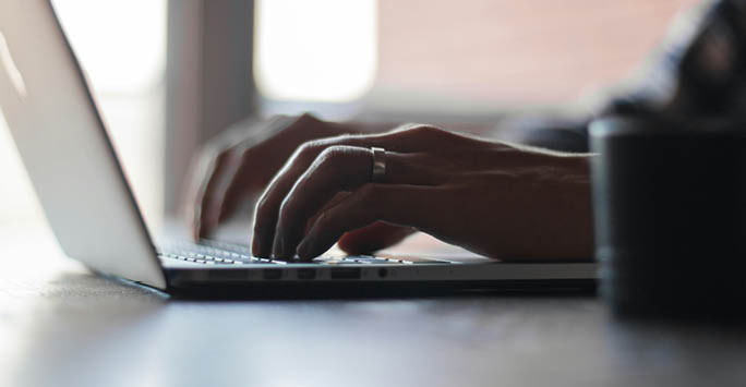 Someone typing on a laptop