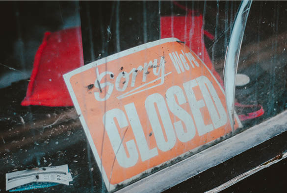A run down sign that reads \'Sorry we\'re closed\'.