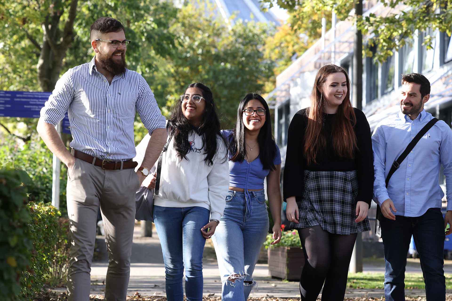 Five students walking through campus near the Guild of Students and Metropolitan Cathedral.