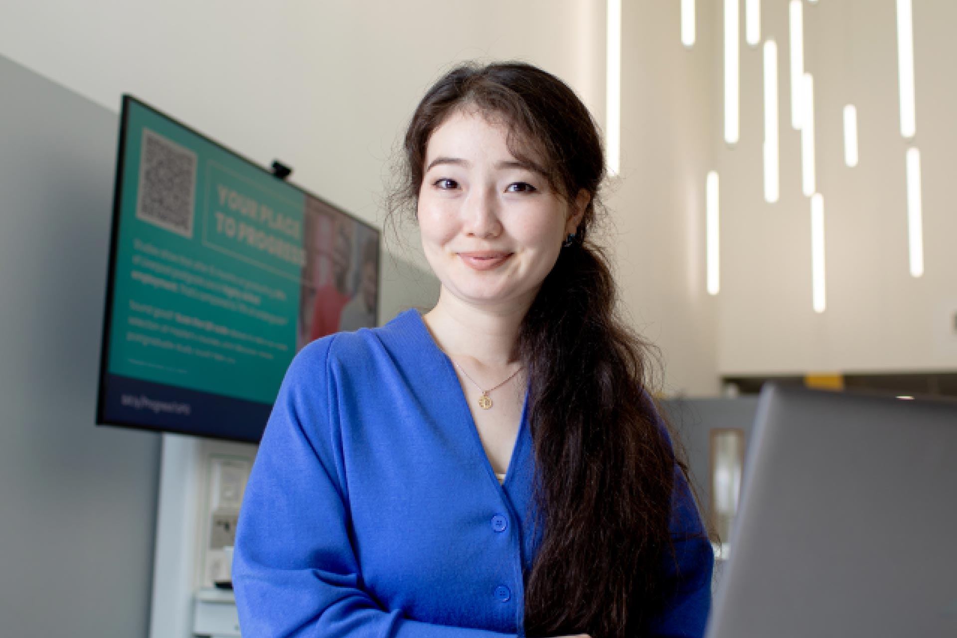 A postgraduate researcher working on a laptop.