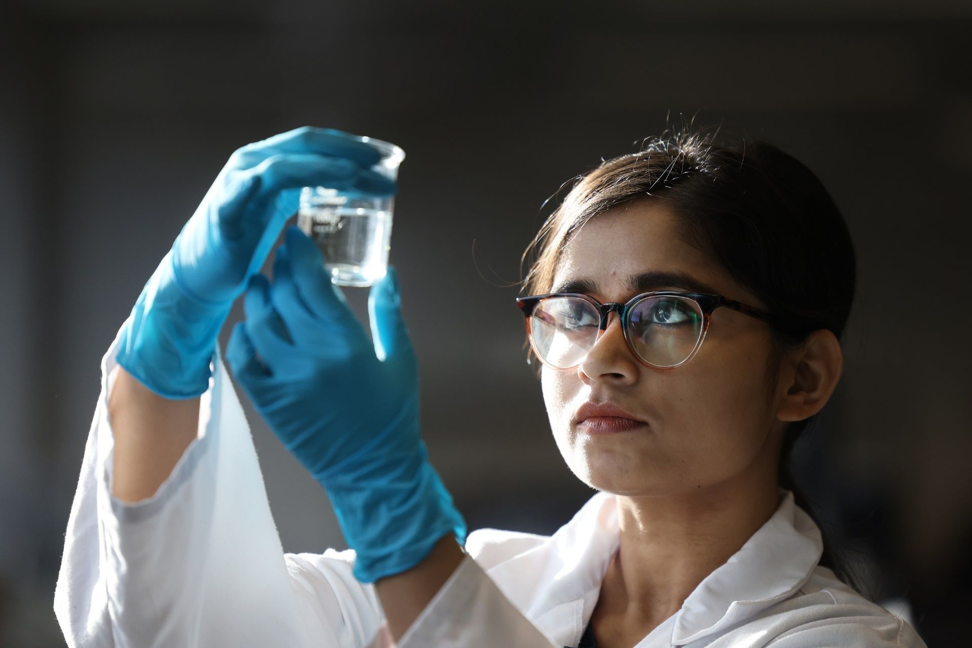 Student conducting experiment with beaker