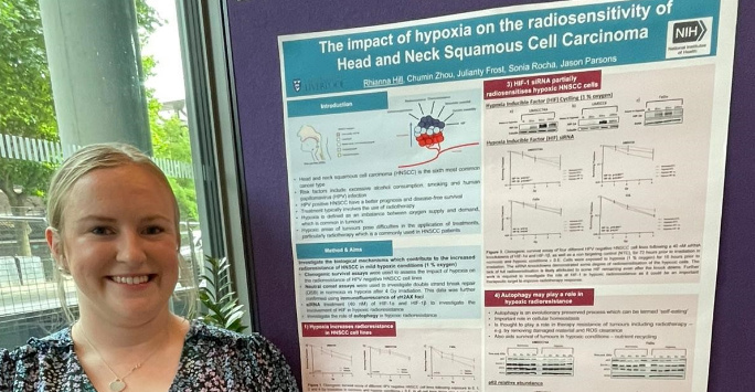 Rhianna standing with her poster presentation