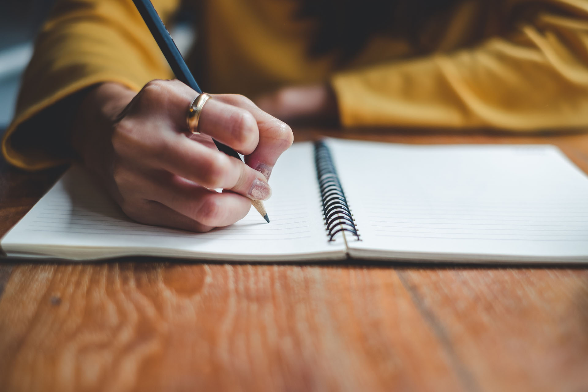 Woman writing on a notepad