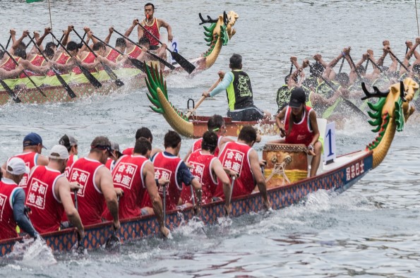 Dragon boat with people paddling racing on a river