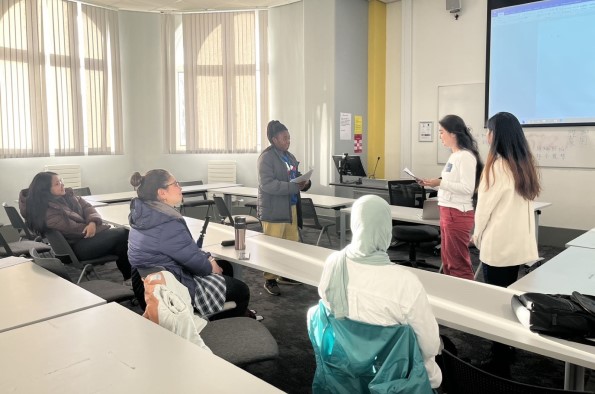 Students sat at tables learning Mandarin in classroom