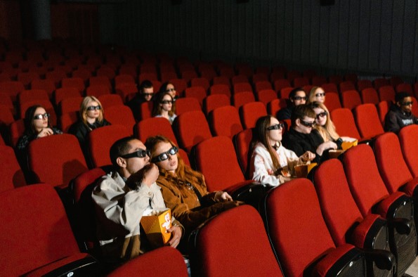 People sat in cinema seats watching the screen